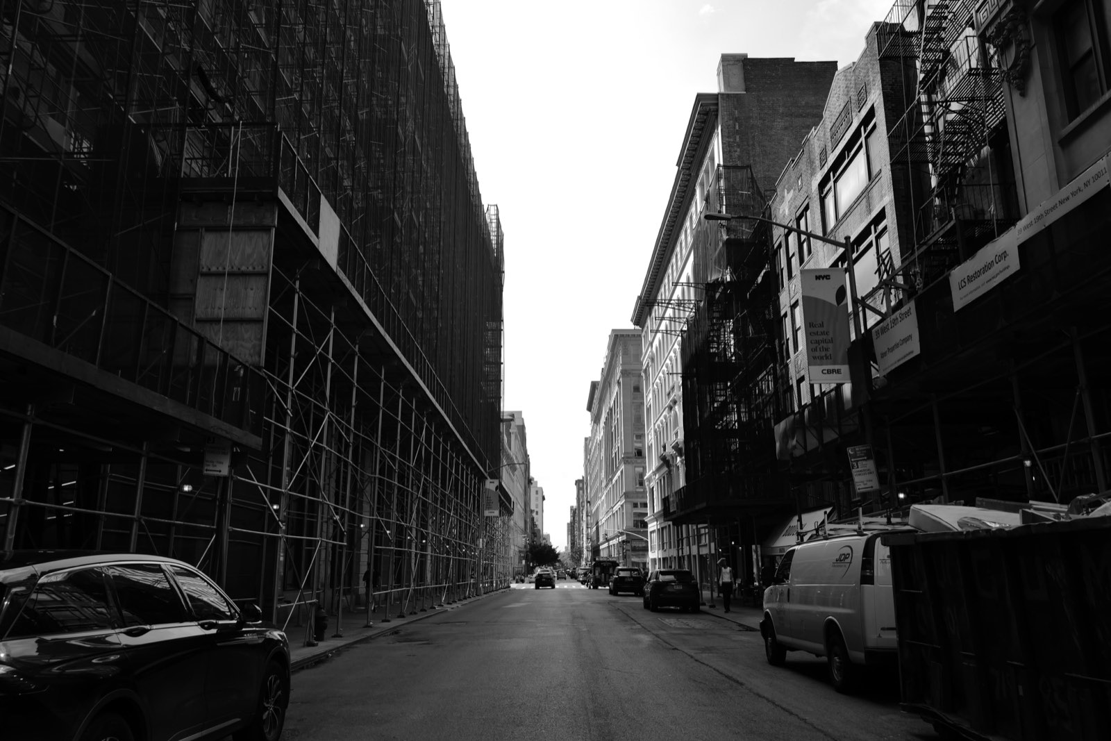 The block under scaffolding, seen from the middle of the street