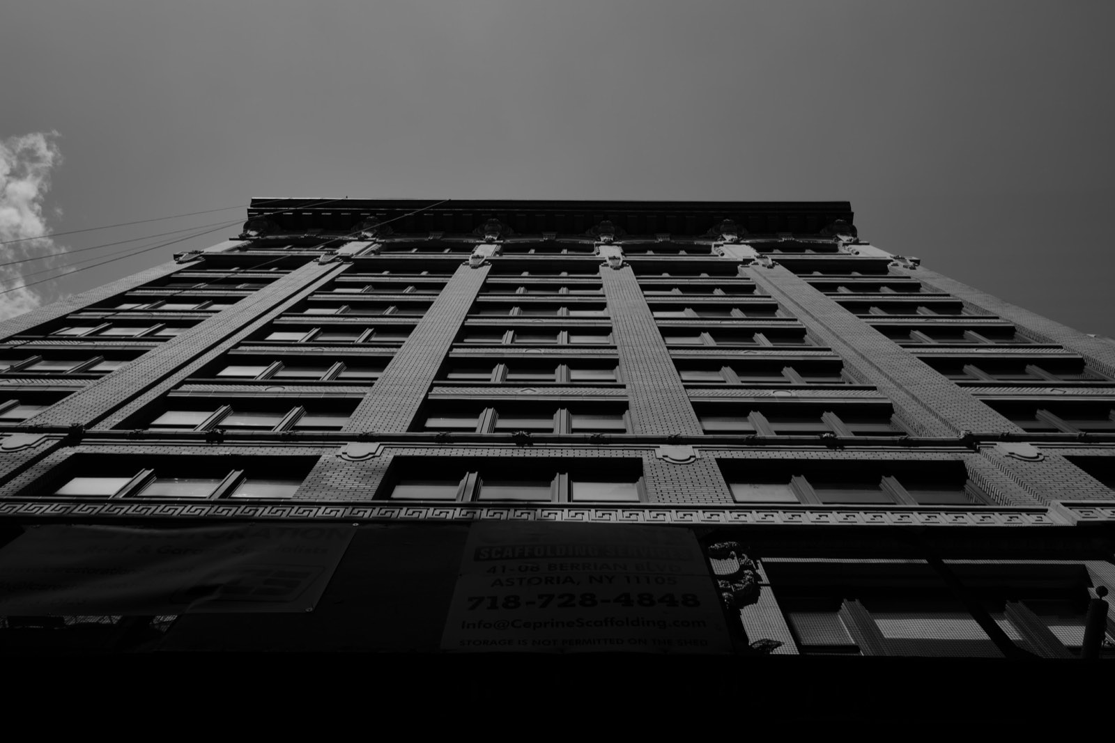 The 1910 brick facade of the building, seen from the sidewalk