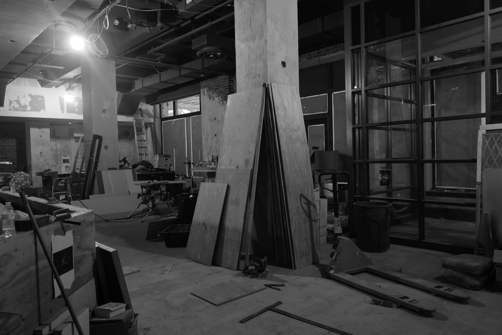 Lumber and a work lamp inside the dining room under construction