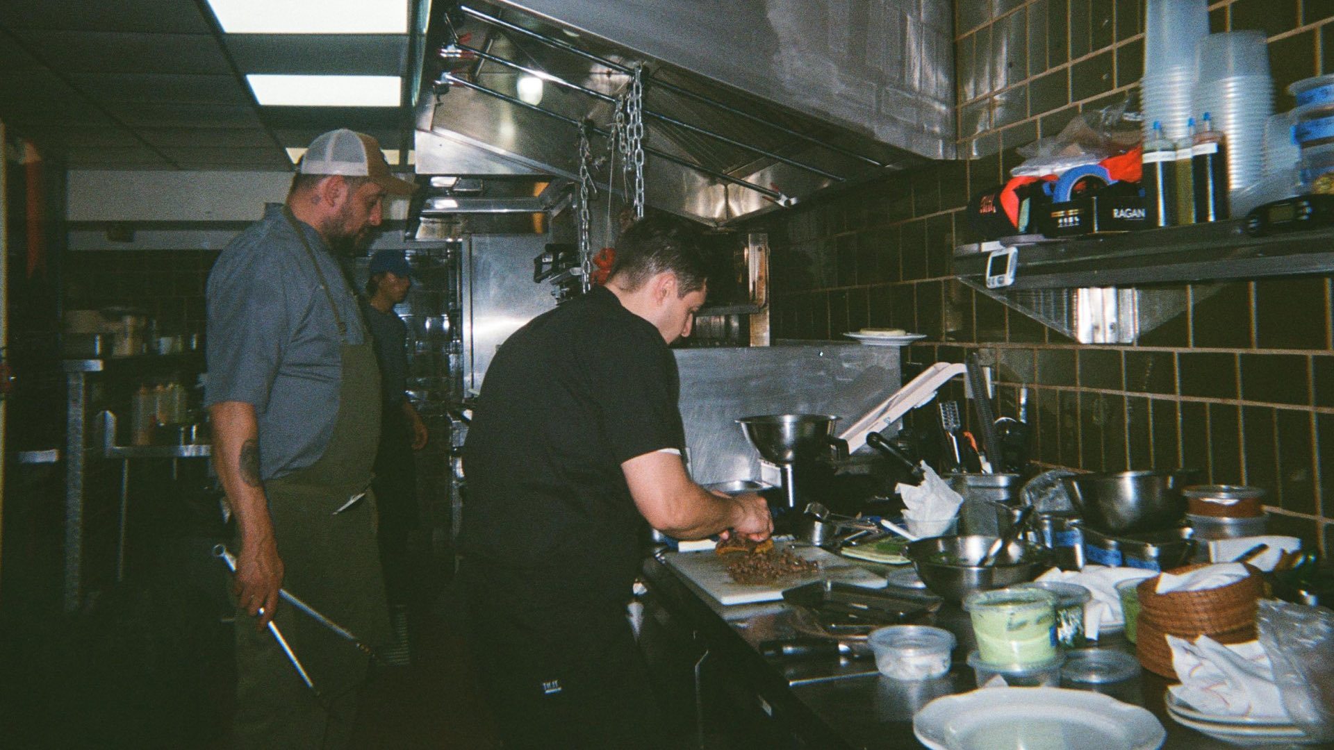 Three cooks working the line together during service